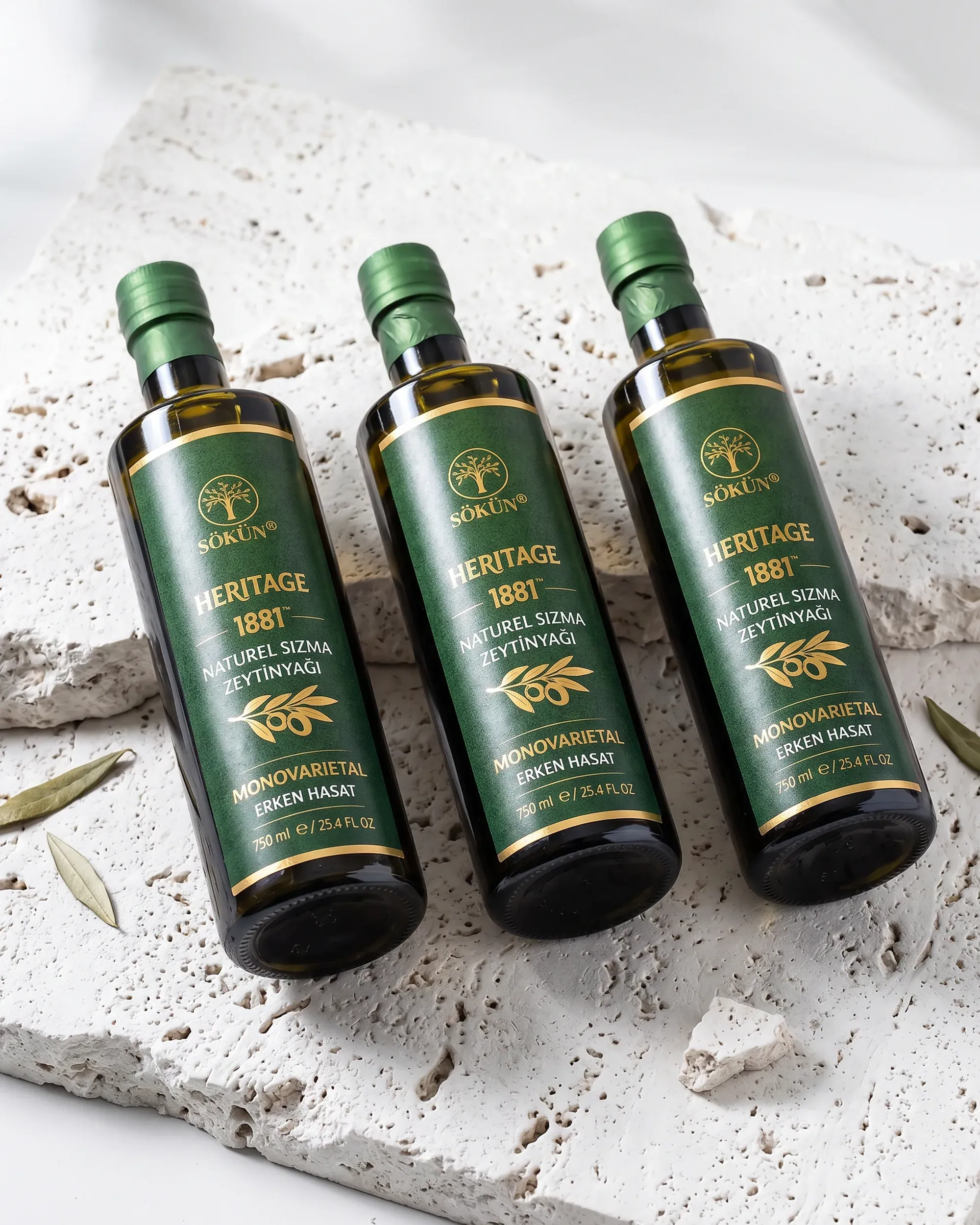 Three bottles lying on a pale stone slab, seen from above